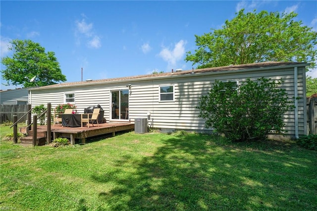 rear view of property with a deck and central AC
