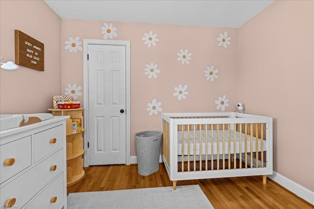 1126 Larchmont Cres, Norfolk, VA 23508 - bedroom with a crib, wood finished floors, and baseboards