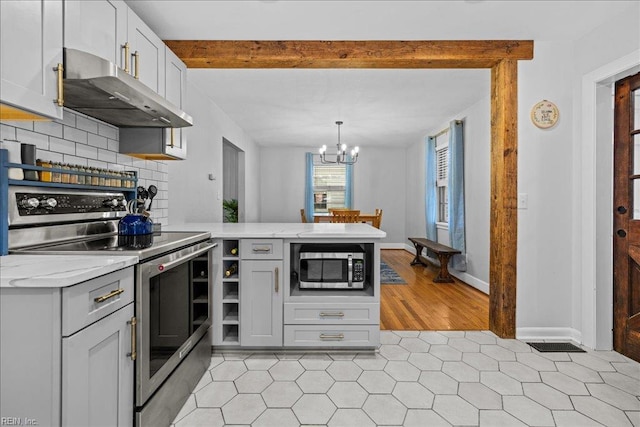 1126 Larchmont Cres, Norfolk, VA 23508 - kitchen with stainless steel appliances, under cabinet range hood, a peninsula, a chandelier, and light stone countertops