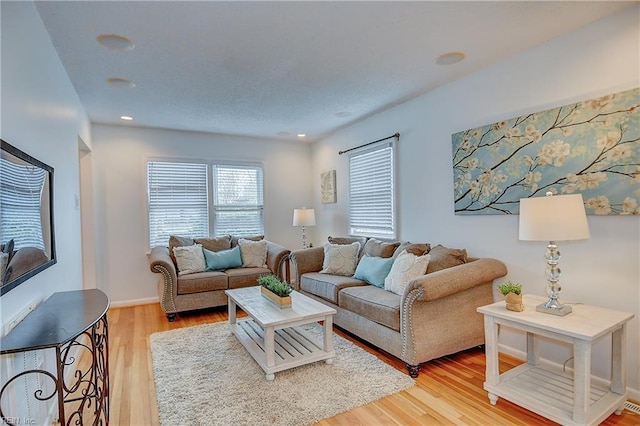 living area with light wood-style floors and recessed lighting