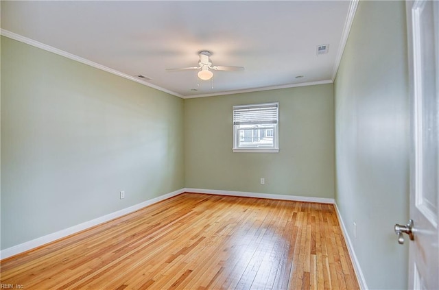 spare room with light wood finished floors, a ceiling fan, baseboards, and ornamental molding