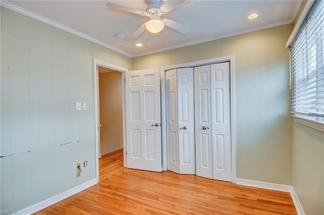 unfurnished bedroom with light wood finished floors, baseboards, crown molding, a closet, and recessed lighting