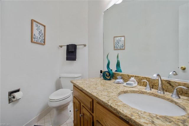 bathroom featuring toilet, tile patterned flooring, vanity, and baseboards