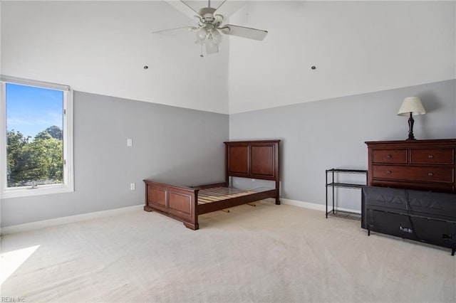 bedroom with high vaulted ceiling, light colored carpet, baseboards, and ceiling fan