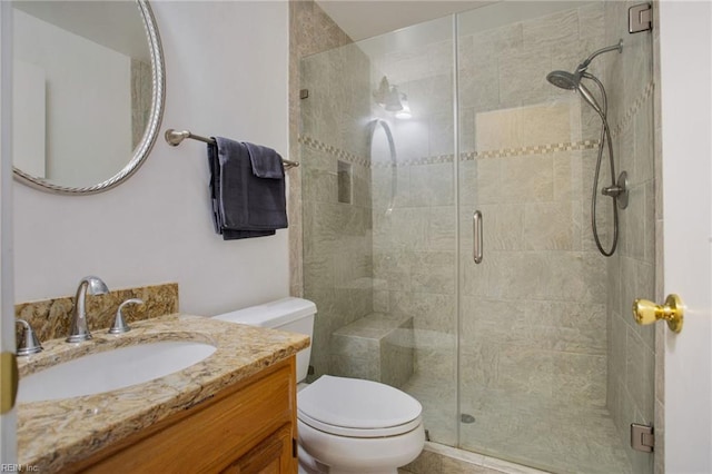 full bath with toilet, a shower stall, and vanity
