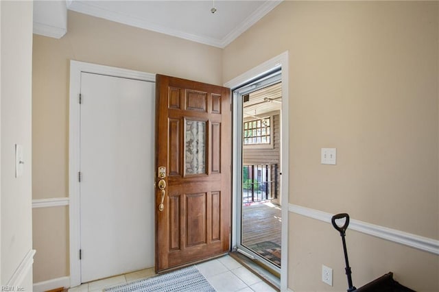 entryway with crown molding, light tile patterned floors, and baseboards