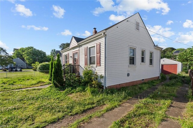 6459 Clare Rd, Norfolk, VA 23513 - view of property exterior featuring a chimney, crawl space, fence, and a detached garage