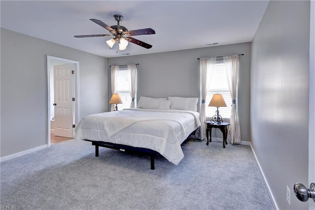 bedroom featuring multiple windows, baseboards, carpet flooring, and ceiling fan