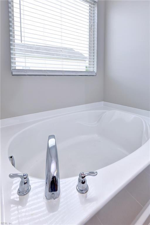 full bathroom with a bath