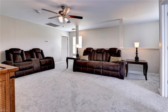 carpeted living room featuring ceiling fan and baseboards