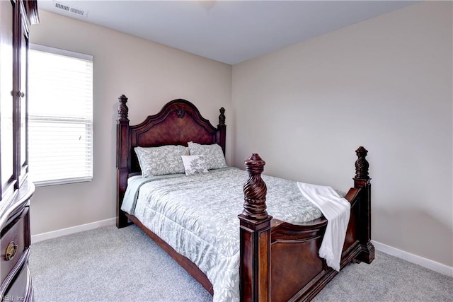 bedroom featuring carpet flooring, multiple windows, and baseboards