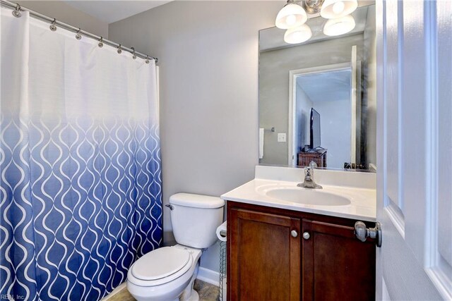 bathroom featuring toilet and vanity