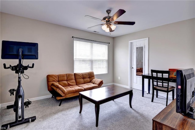 living area with carpet floors, baseboards, and a ceiling fan