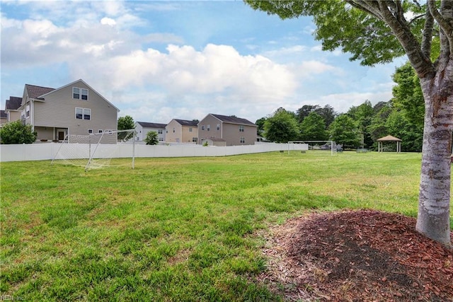 view of yard featuring fence, a gazebo, and a residential view