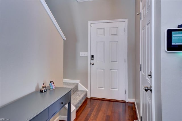 entryway featuring dark wood finished floors and baseboards