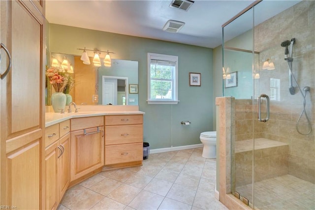 bathroom with a shower stall, tile patterned flooring, vanity, and toilet