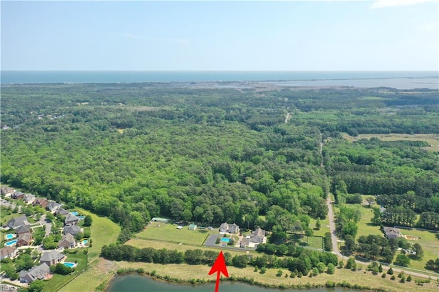aerial overview of property's location featuring a heavily wooded area and a nearby body of water