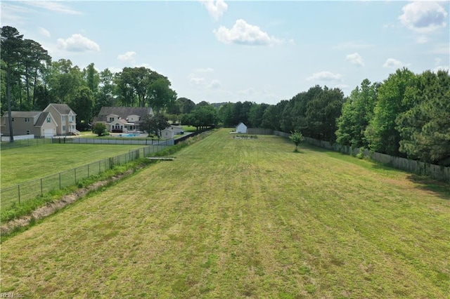 view of yard featuring fence and a view of rural / pastoral area