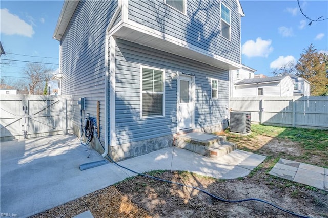 248 Pinner St, Suffolk, VA 23434 - back of house featuring a fenced backyard, central AC unit, a gate, and a patio