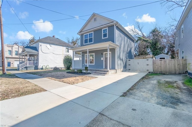 248 Pinner St, Suffolk, VA 23434 - view of front of house featuring a gate, covered porch, driveway, and fence