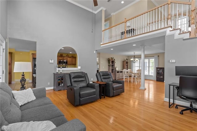110 Lands End Dr, Elizabeth City, NC 27909 - living area featuring ornamental molding, wood finished floors, a towering ceiling, ceiling fan, and a chandelier