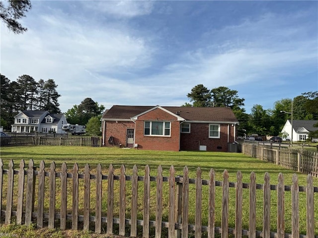 view of front facade featuring brick siding and a front yard