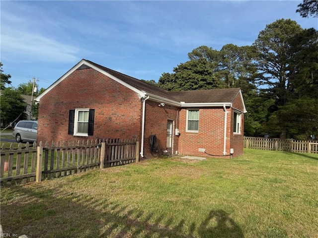 view of side of property featuring brick siding and a shingled roof