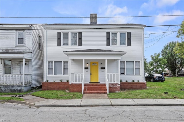 819 Lincoln St, Portsmouth, VA 23704 - view of front facade featuring covered porch, a chimney, and a front yard
