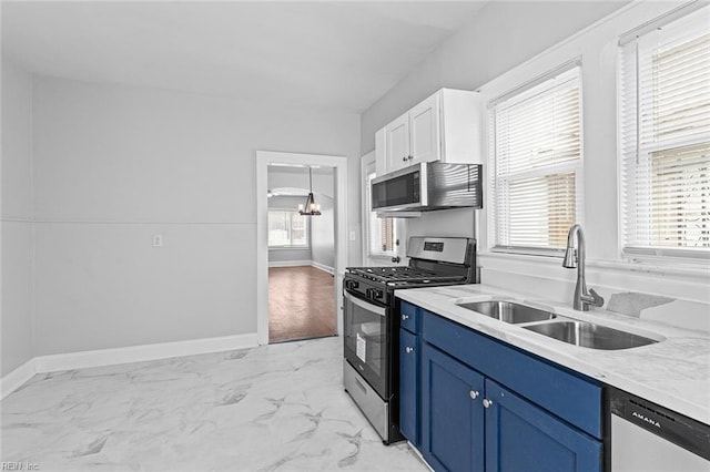 819 Lincoln St, Portsmouth, VA 23704 - kitchen with appliances with stainless steel finishes, a sink, blue cabinets, light marble finish flooring, and baseboards