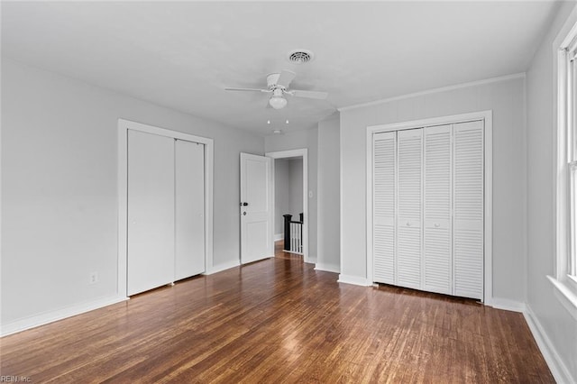 819 Lincoln St, Portsmouth, VA 23704 - unfurnished bedroom with multiple closets, wood finished floors, and baseboards
