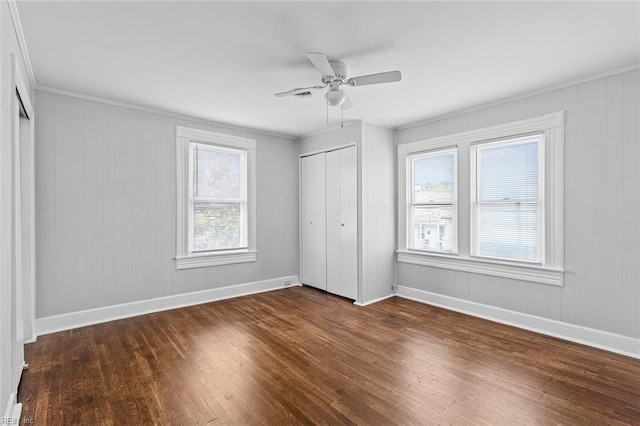 819 Lincoln St, Portsmouth, VA 23704 - unfurnished bedroom with dark wood finished floors, baseboards, a closet, a ceiling fan, and crown molding