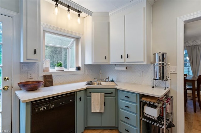 kitchen featuring black dishwasher, white cabinetry, backsplash, a sink, and ornamental molding
