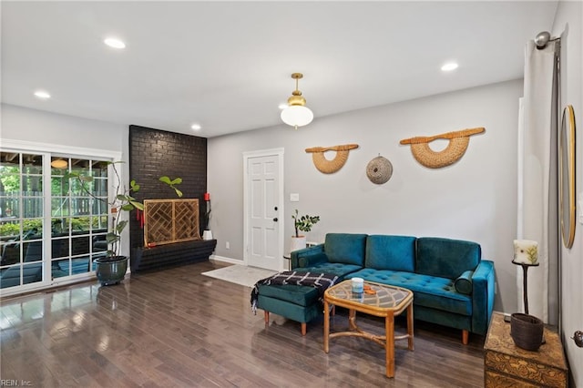 living area featuring wood finished floors, recessed lighting, a fireplace, and baseboards