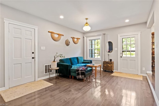 entryway featuring wood finished floors, baseboards, and recessed lighting