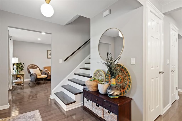 entryway with wood finished floors, baseboards, stairway, and recessed lighting