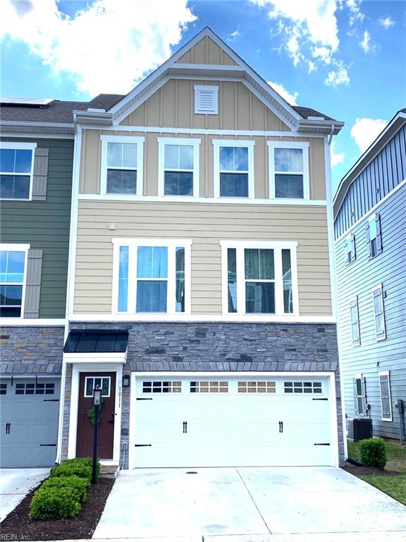 1011 Gabion Way, Chesapeake, VA 23323 - view of front of house featuring a garage, concrete driveway, stone siding, and board and batten siding