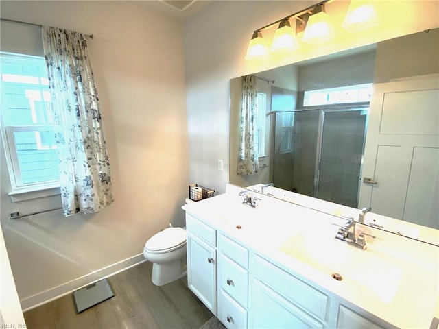 1011 Gabion Way, Chesapeake, VA 23323 - bathroom featuring wood finished floors, a stall shower, toilet, baseboards, and double vanity