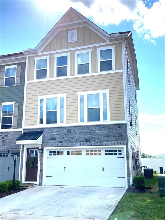 1011 Gabion Way, Chesapeake, VA 23323 - view of front of home with stone siding, a garage, driveway, and board and batten siding