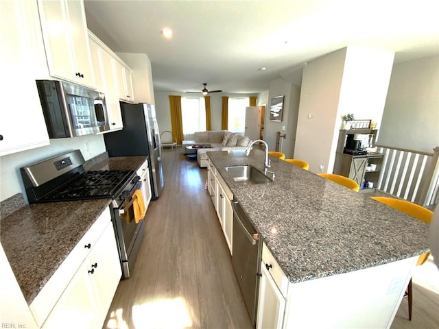 1011 Gabion Way, Chesapeake, VA 23323 - kitchen featuring a sink, appliances with stainless steel finishes, wood finished floors, a kitchen breakfast bar, and an island with sink