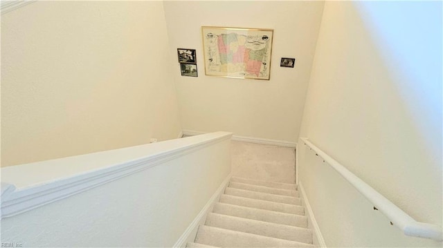 staircase with baseboards and carpet flooring