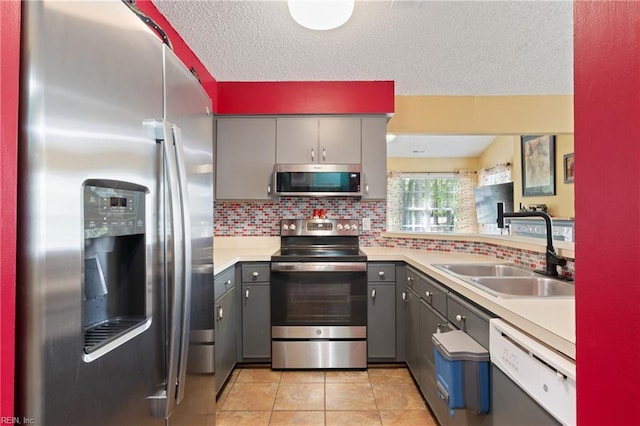 1005 Villas Ct, Virginia Beach, VA 23456 - kitchen featuring appliances with stainless steel finishes, gray cabinetry, a sink, and a textured ceiling