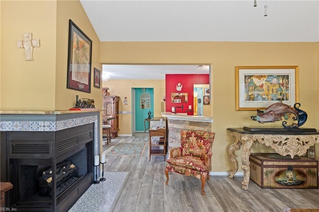 1005 Villas Ct, Virginia Beach, VA 23456 - sitting room featuring a tile fireplace, wood finished floors, baseboards, and vaulted ceiling