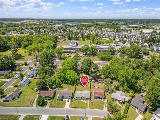 view of property location with nearby suburban area, a notable bridge, and a tree filled landscape