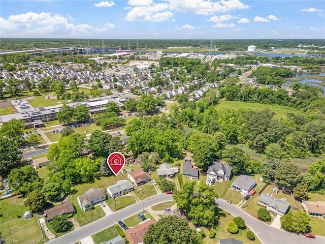 view of property location with a large body of water, a notable bridge, and nearby suburban area