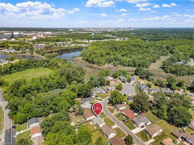aerial overview of property's location with a nearby body of water and nearby suburban area
