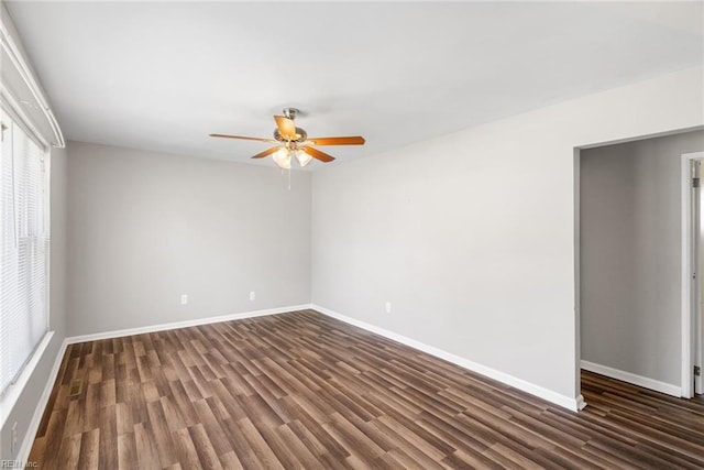 unfurnished room with ceiling fan, wood finished floors, and baseboards