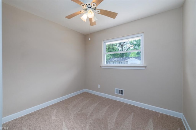 carpeted spare room with baseboards and ceiling fan