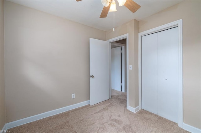 unfurnished bedroom featuring carpet floors, a closet, a ceiling fan, and baseboards