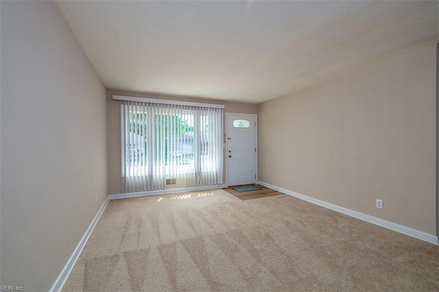 unfurnished room with carpet floors and baseboards