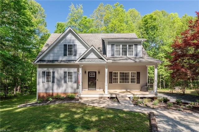 view of front of property featuring covered porch, a front yard, and roof with shingles
